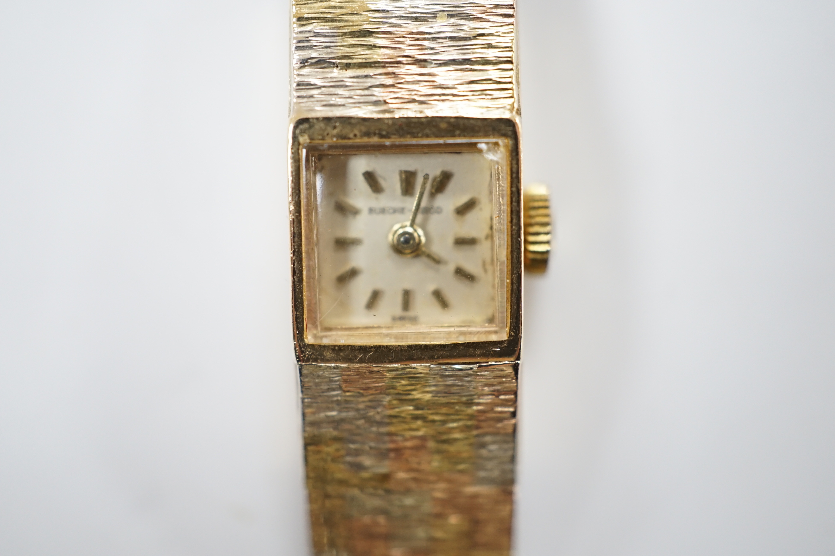 A lady's 9ct three colour gold Beuche Girod manual wind bracelet wrist watch, overall 16.7cm, gross weight 30.1 grams.